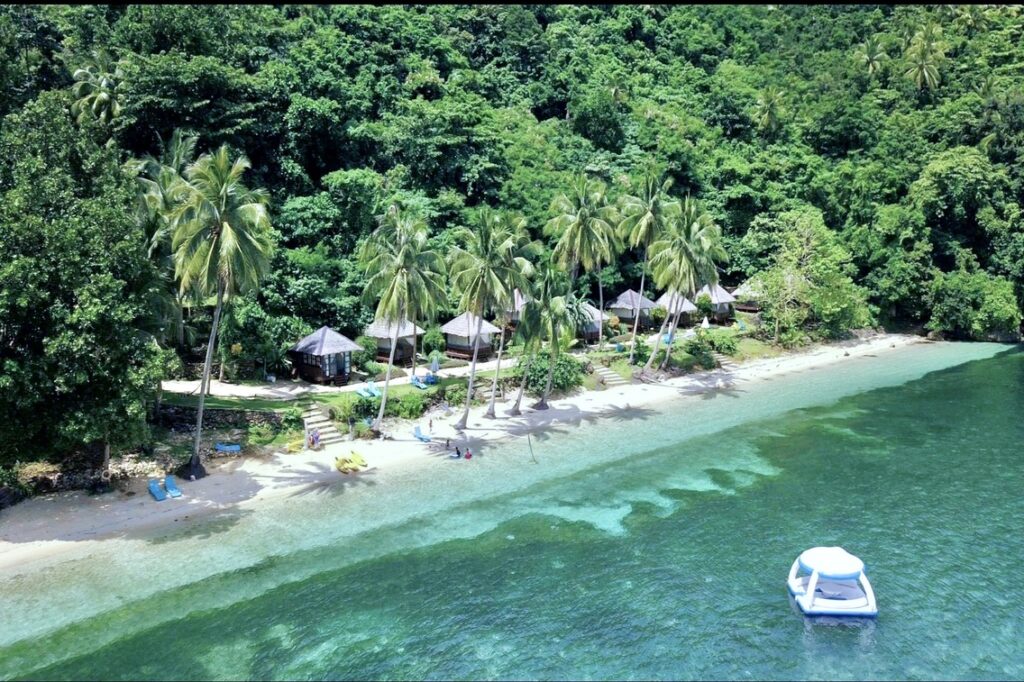 Aerial view of Tuburan Cove Beach Resort showing beachfront casitas white sand beach palm trees and turquoise waters Buruanga Aklan Philippines